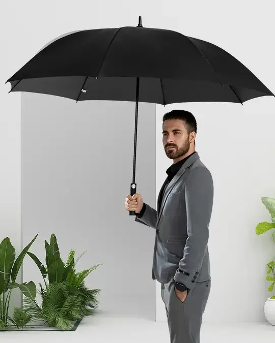 Custom premium business golf umbrella lifestyle shot, classic black straight promotional umbrella supplied by a China manufacturer for corporate executive gift wholesale.