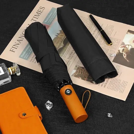 Custom corporate gift umbrella product shot, featuring a premium wooden handle automatic folding umbrella with a sleeve supplied by a China manufacturer for wholesale.