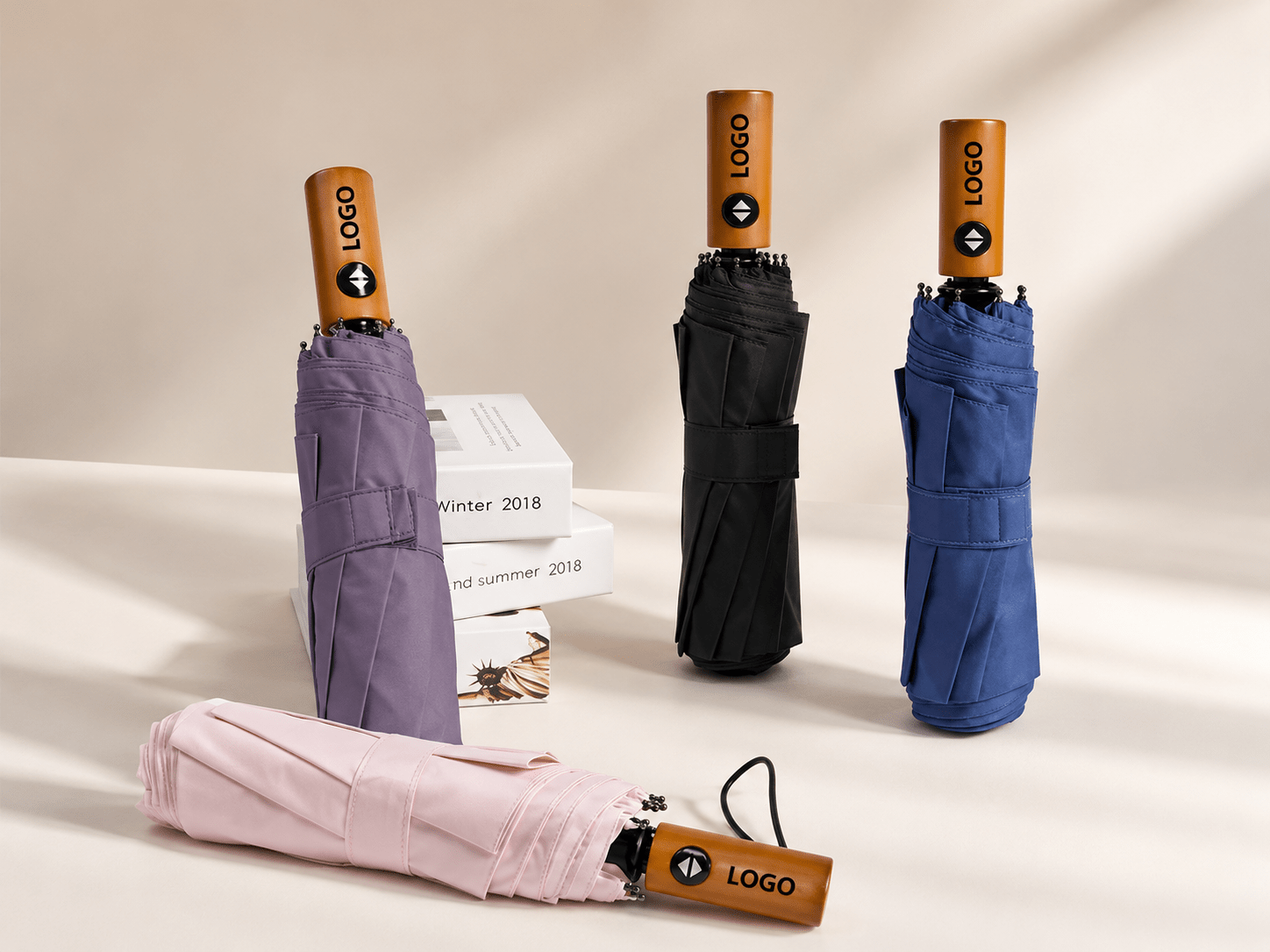 Custom wooden handle automatic umbrellas in multiple colors for corporate gifts, highlighting laser-engraved logo customization on handles provided by the manufacturer for volume wholesale.